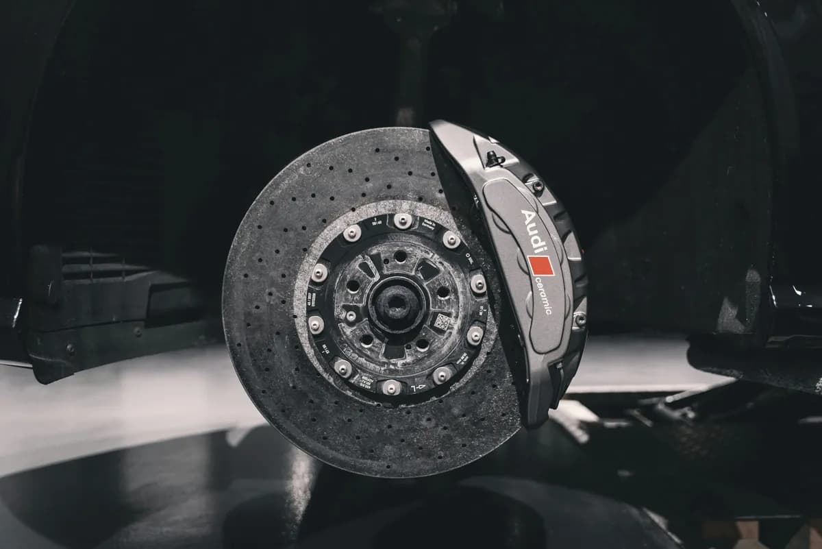 Mechanic inspecting vehicle brake assembly
